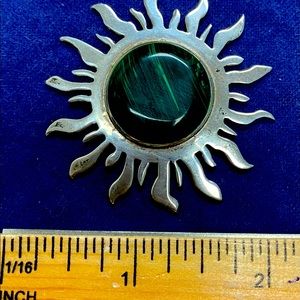 Silver pendant with deep green stone.